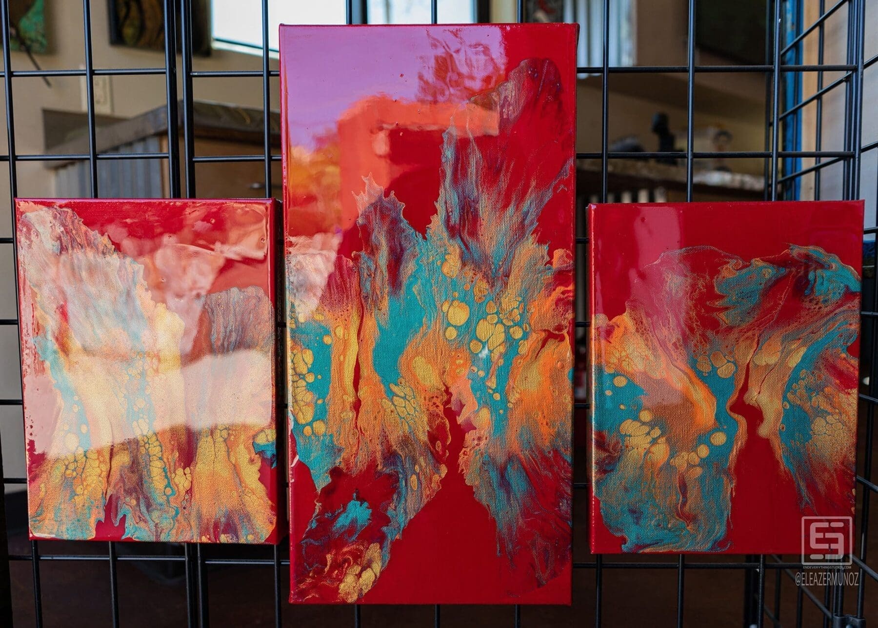 A turquoise textured bull skull sculpture hangs above smaller artworks and a warm-toned abstract painting.